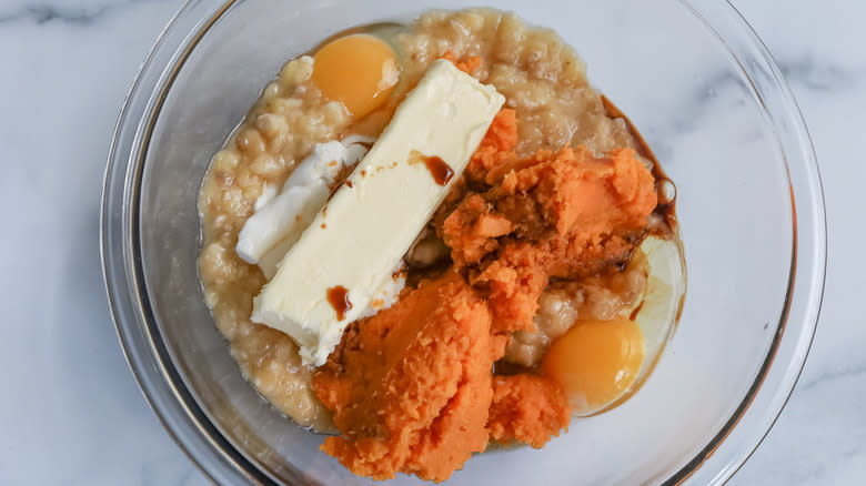 Overview of mashed sweet potato and ingredients in mixing bowl