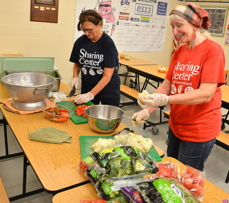 Volunteers Gerri Glenn and Cheryl Mahan prep for a Monday meal at the Central Brevard Sharing Center.