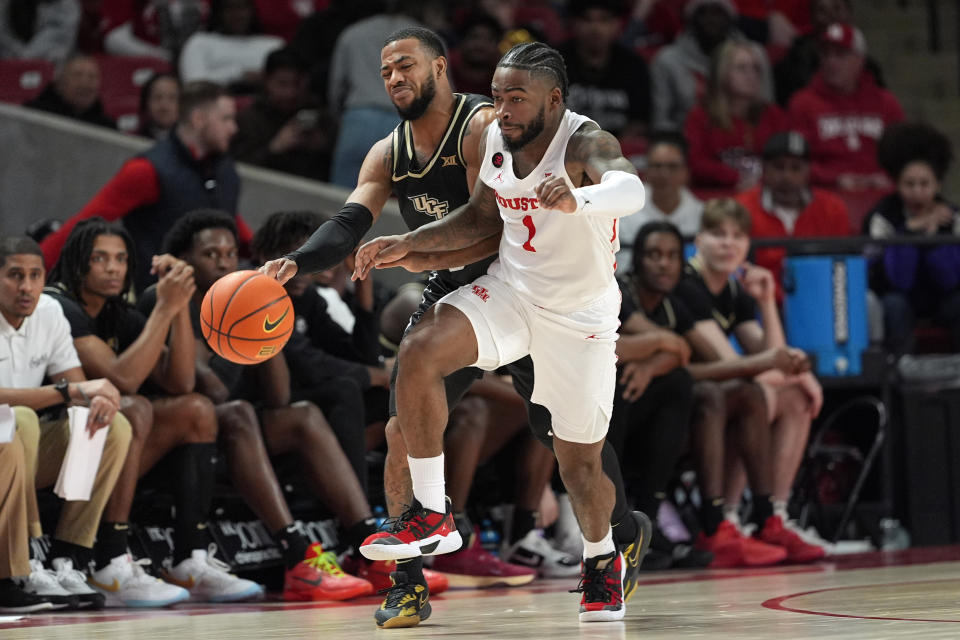 Houston's Jamal Shead (1) steals the ball from Central Florida's Darius Johnson (3) during the second half of an NCAA college basketball game Saturday, Jan. 20, 2024, in Houston. (AP Photo/David J. Phillip)