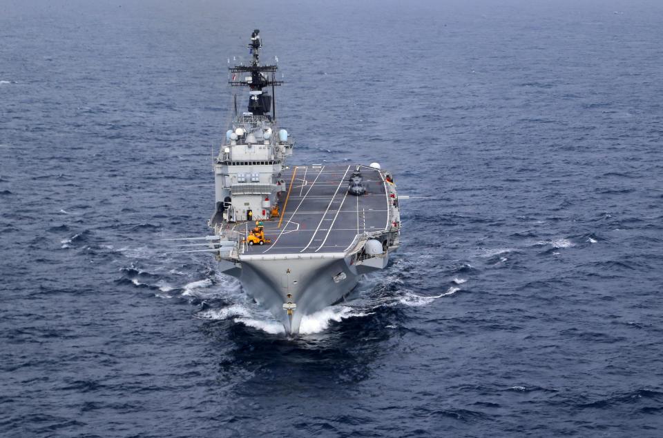 FILE - The Italian Navy Giuseppe Garibaldi light aircraft carrier, seen from a helicopter, sails on the Mediterranean Sea, off the coast of Sicily, on Nov. 25, 2016 part of the European Union's naval force Operation Sophia. A confidential European Union military report calls for the continued support and training of Libya’s coastguard and navy despite concerns about their treatment of migrants, a mounting death toll at sea, and the continued lack of any central authority in the North African nation. The report circulated to EU officials on Jan. 4 and obtained by The Associated Press offers a rare insight into Europe’s determination to cooperate with Libya and its role in the interception and return of thousands of men, women and children to a country where they face insufferable abuse. (AP Photo/Nicolae Dumitrache, File)