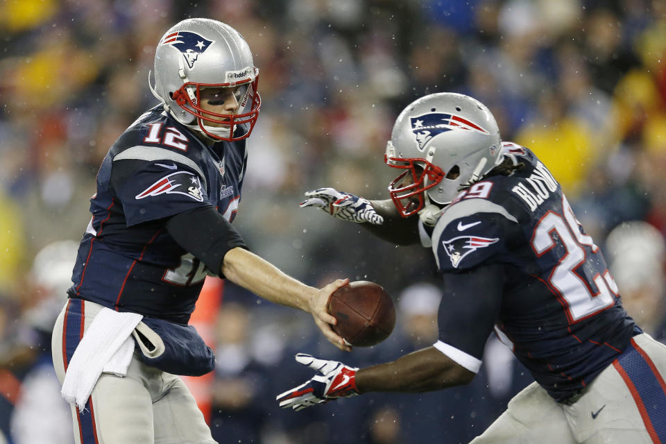 New England Patriots quarterback Tom Brady (12) hands off the ball to running back LeGarrette Blount (29) during the first half of an AFC divisional NFL playoff football game against the Indianapolis Colts in Foxborough, Mass., Saturday, Jan. 11, 2014. (AP Photo/Michael Dwyer)