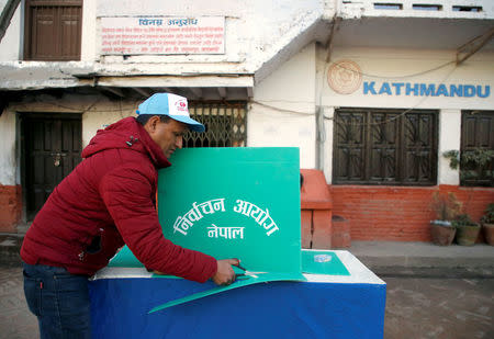 An election officer sets up a booth at a polling station a day ahead of the parliamentary and provincial elections in Kathmandu, Nepal December 6, 2017. REUTERS/Navesh Chitrakar