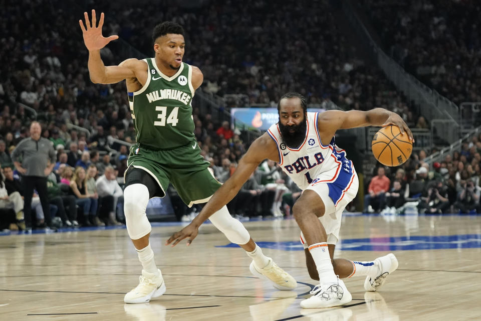 Philadelphia 76ers' James Harden (1) dribbles against Milwaukee Bucks' Giannis Antetokounmpo during the first half of an NBA basketball game Saturday, March 4, 2023, in Milwaukee. (AP Photo/Aaron Gash)