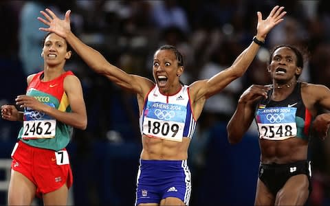 Great Britain's gold medal winner Kelly Holmes (centre) crosses the finishing line to win the Women's 800m at the Olympic Stadium during the Olympic Games in Athens - Credit: PA