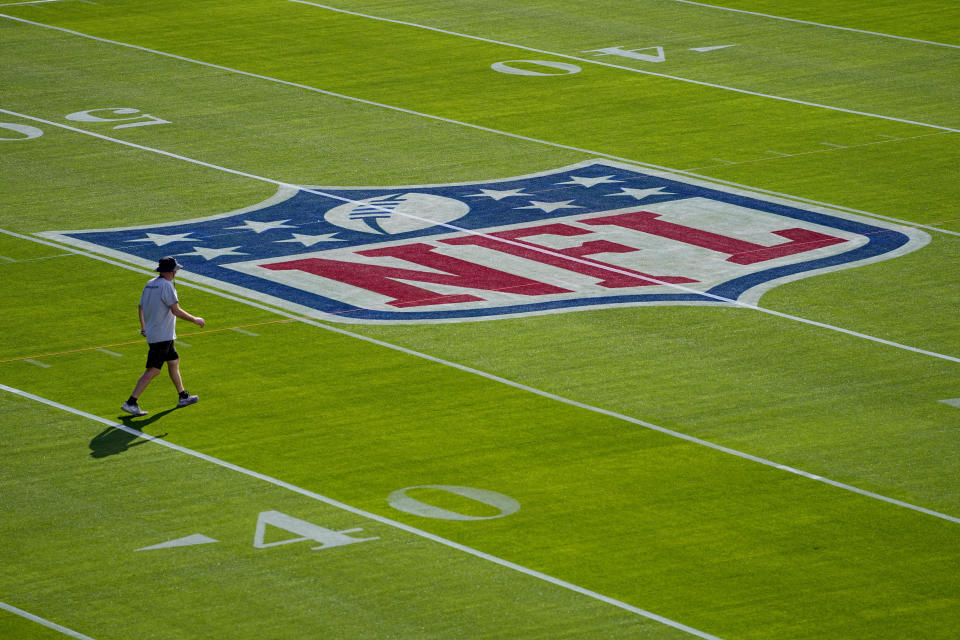 Workers prepare the field outside Allegiant Stadium ahead of Super Bowl 58, Wednesday, Jan. 31, 2024, in Las Vegas. (AP Photo/Matt York)