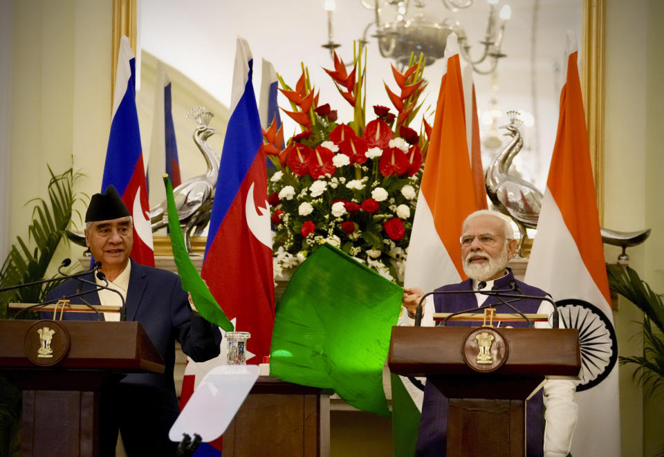 Indian Prime Minister Narendra Modi, right, and his Nepalese counterpart Sher Bahadur Deuba remotely inaugurate a railway line between Jaynagar in India to Kurthal in Nepal, in New Delhi, India, Saturday, April 2, 2022. Deuba is on a three-day official visit to India. (AP Photo/Manish Swarup)