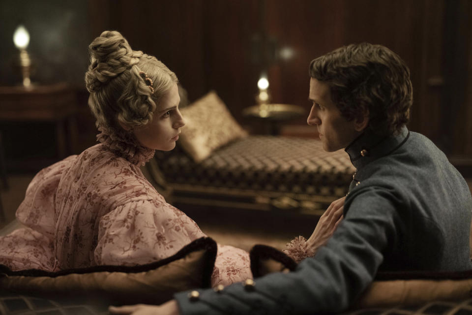 This image released by Netflix shows Lucy Boynton as Lea Marquis, left, and Harry Melling as Edgar Allan Poe in a scene from "The Pale Blue Eye." (Scott Garfield/Netflix via AP)