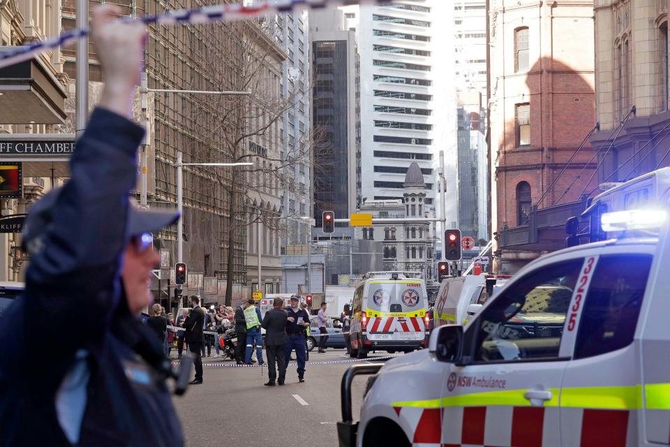 Emergency workers stand at the scene in Sydney (AP)