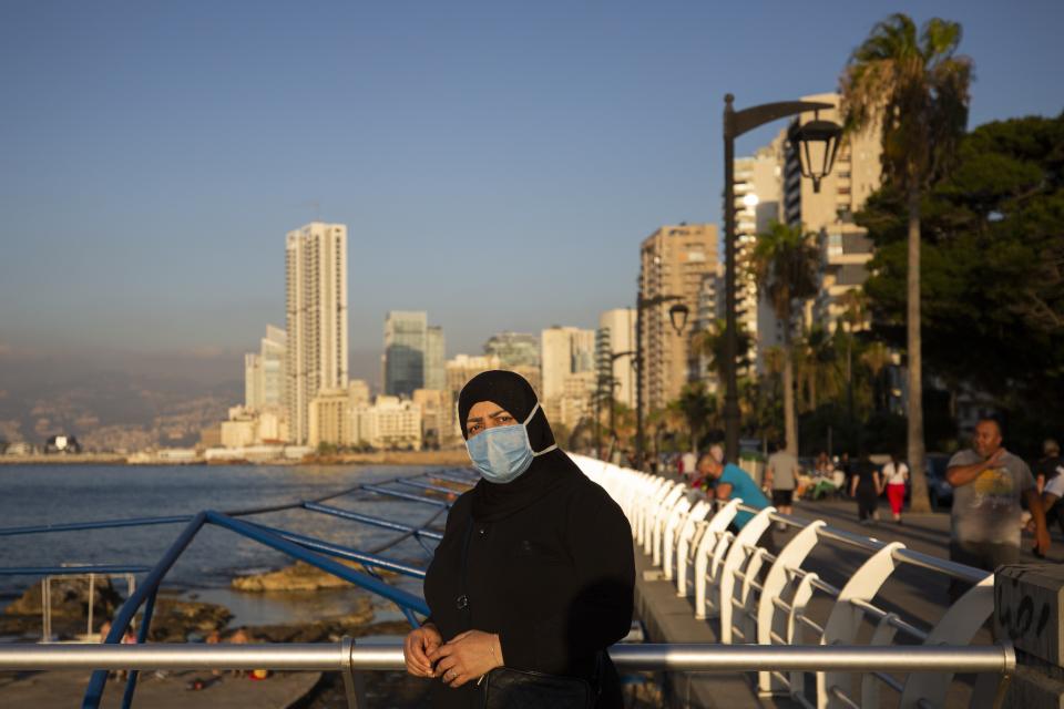 Tahiyah Chmayssani poses for a picture at the Mediterranean Sea corniche in Beirut, Lebanon, Tuesday, July 21, 2020. What would you say to someone if you wanted to convince them to wear a mask: I would say be concerned for your own safety before that of others," Not wear a mask?: "you don't care for yourself" (if you don't wear it). "you don't care for yourself" (if you don't wear it). (AP Photo/Hassan Ammar)