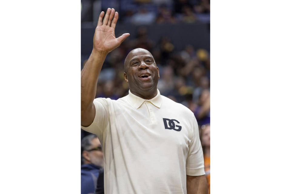 FILE - NBA Hall of Fame player Irvin Magic Johnson attends a Los Angeles Sparks against the Phoenix Mercury WNBA basketball game, Friday, May 19, 2023, in Los Angeles. Magic Johnson's love of basketball motivated him to save the Los Angeles Sparks from folding and also put him on the leading edge of what is now a growing WNBA trend. Ten years after becoming the majority owner the team's value has increased and other former professional athletes are buying into the league. (AP Photo/Jeff Lewis, File)