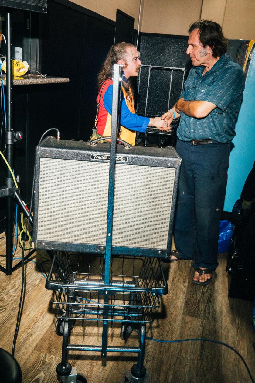 Two men shake hands at Laundry Wand.