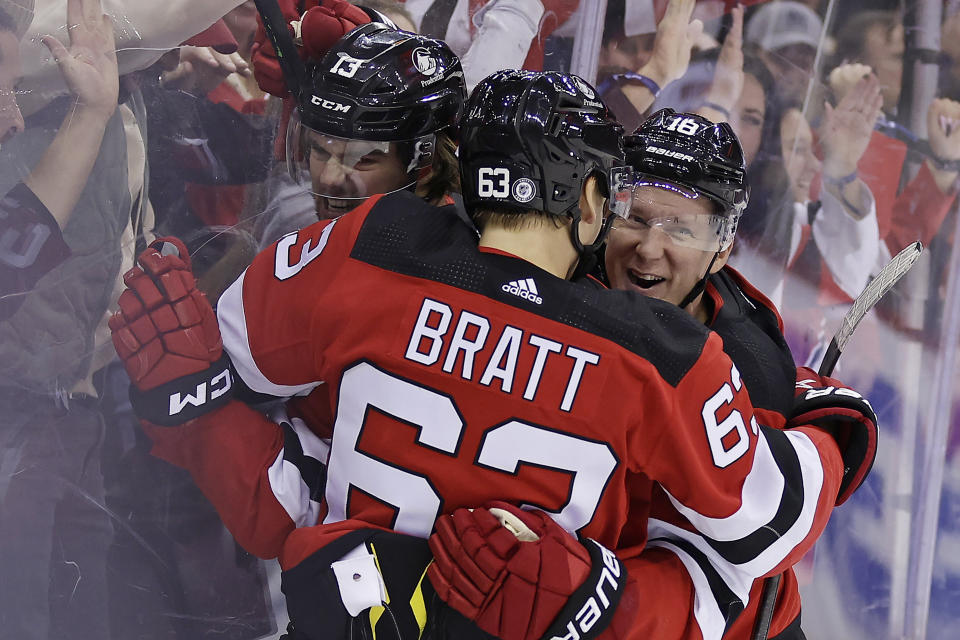 New Jersey Devils center Nico Hischier (13) is congratulated by Ondrej Palat and Jesper Bratt (63) after his against the Washington Capitals during the second period of an NHL hockey game Wednesday, Oct. 25, 2023, in Newark, N.J. (AP Photo/Adam Hunger)