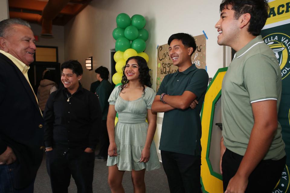 Coachella Valley Unified School District trustee Jesus Gonzalez, left, talks to Coachella Valley High School seniors Nevaeh Robles, second from left, Kamila Cortes Ramirez, Jose Arreola and Miguel Gonzalez prior to the start of an assembly where they were awarded $20,000 scholarships from BNP Paribas, in Thermal, Calif., on March 14, 2024.