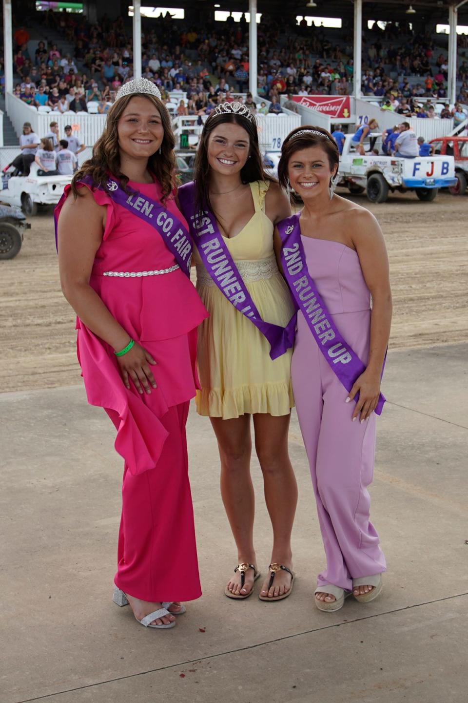 2022 Lenawee County Fair Queen Kindell Covey, left, is pictured with first runner-up Emily Maran, center, and second runner-up Kayleigh Barrett before the figure 8 demolition derby Wednesday at the Lenawee County Fair.