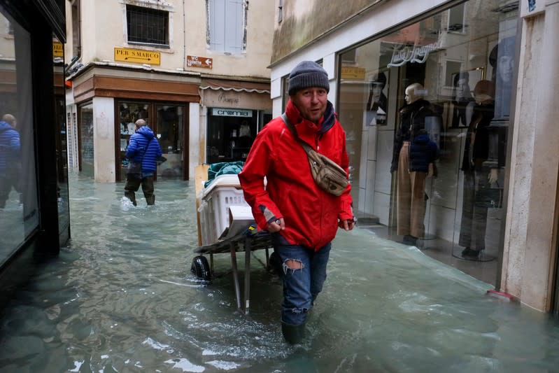 A man walks outside during exceptionally high water levels in Venice