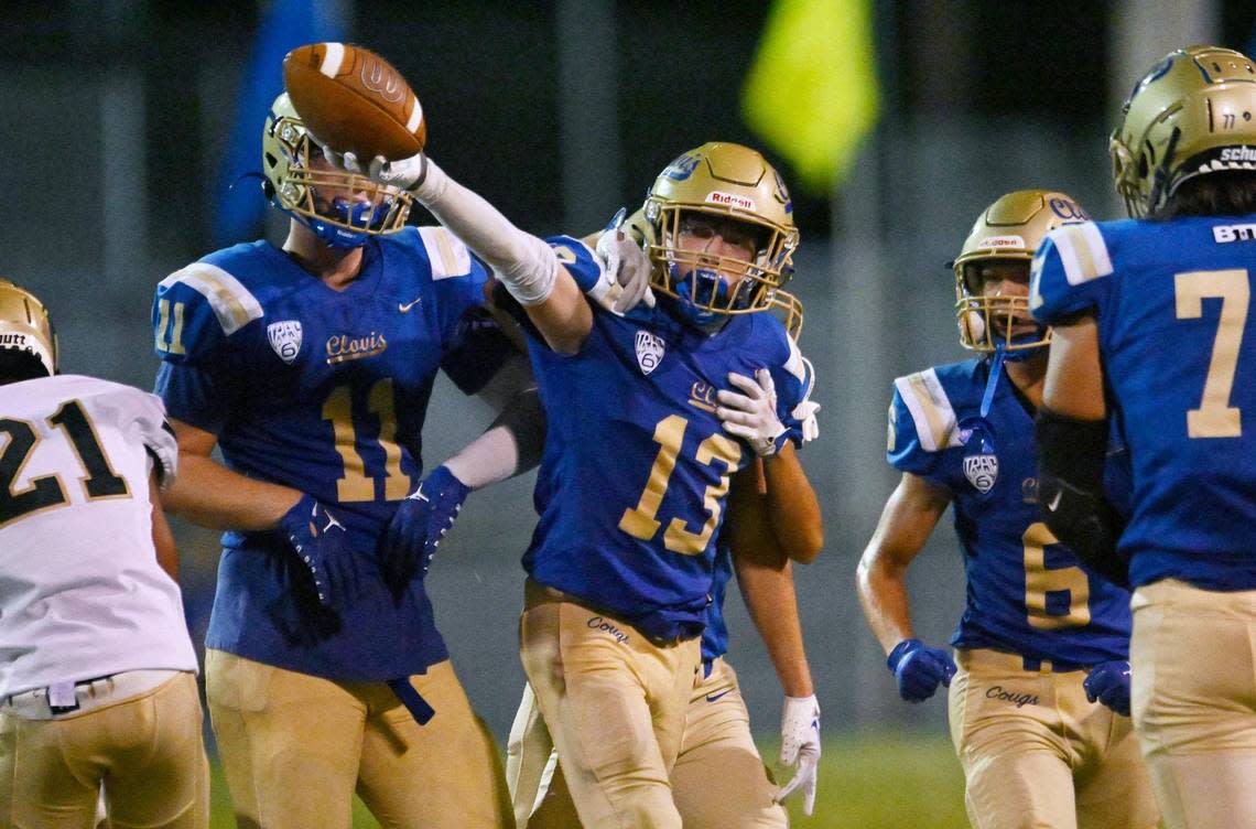 Clovis High’s Palmer Johnson, center, celebrates his interception against Graces Thursday, Aug. 17, 2023 in Clovis. ERIC PAUL ZAMORA/ezamora@fresnobee.com