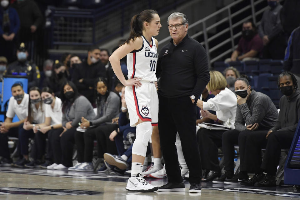 Connecticut's Nika Mühl talks with coach Geno Auriemma during the first half of the team's NCAA college basketball game against Seton Hall, Friday, Jan. 21, 2022, in Storrs, Conn. (AP Photo/Jessica Hill)