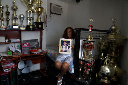 Maria Dalva Correia da Silva holds a photo of her son Thiago, who was killed in the Borel slum in Rio de Janeiro, Brazil, April 22, 2018. Correia da Silva said her 19-year-old son was killed by the police in 2003. REUTERS/Pilar Olivares