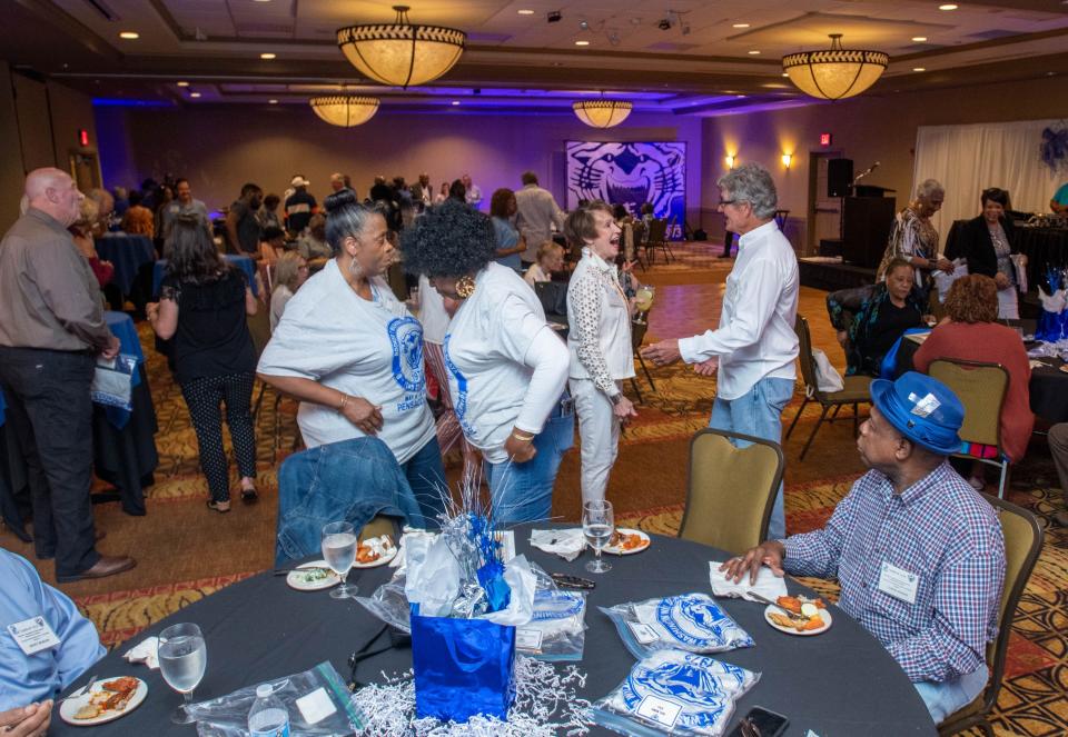 Classmates catch up during Booker T. Washington High School class of 1973’s 50th reunion at the Hilton Garden Inn in Pensacola on Friday, May 5, 2023.  The Class of ’73 was the first to enter and graduate from the then newly desegregated school.