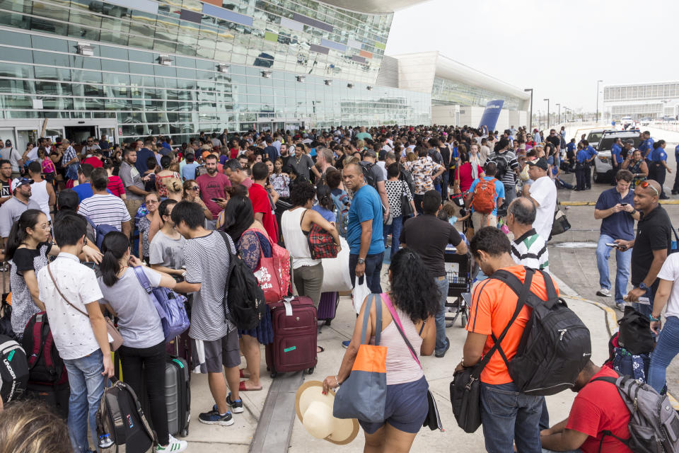 <p>Travelers stand in line outside of Luis Muoz Marn International Airport after Hurricane Maria disrupted flight service in San Juan, Puerto Rico on Wednesday, Sept. 27, 2017. President Donald Trump said he may temporarily suspend a law that restricts the use of foreign ships operating in U.S. waters and between U.S. ports in order to accelerate the delivery of aid to Puerto Rico, where his administration faces mounting criticism over its response to Hurricane Maria. (Photo: Alex Wroblewski/ Bloomberg) </p>