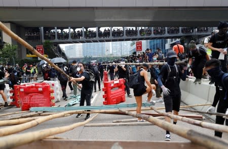 Demonstrators build barricades during a protest in Hong Kong