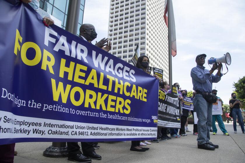 LOS ANGELES, CA - JULY 21: Stan Lyles, vice president of the SEIU-UHW union representing health care workers, speaks at a rally outside the offices of Hospital Association of Southern California to protest a campaign to roll back a measure that would raise the minimum wage to $25 an hour for workers at some privately owned health facilities. Photographed at Downtown on Thursday, July 21, 2022 in Los Angeles, CA. (Myung J. Chun / Los Angeles Times)