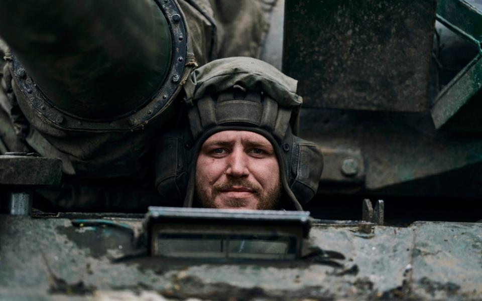 A Ukrainian soldier looks out of a tank on the frontline in Bakhmut - LIBKOS/AP