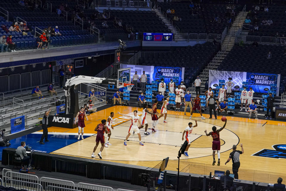 Florida plays against Virginia Tech in the first half of a first round game in the NCAA men's college basketball tournament at Hinkle Fieldhouse in Indianapolis, Friday, March 19, 2021. Restrictions due to the COVID-19 pandemic have limited crowds, reduced interactions and created an abnormal NCAA experience for those involved. (AP Photo/Michael Conroy)