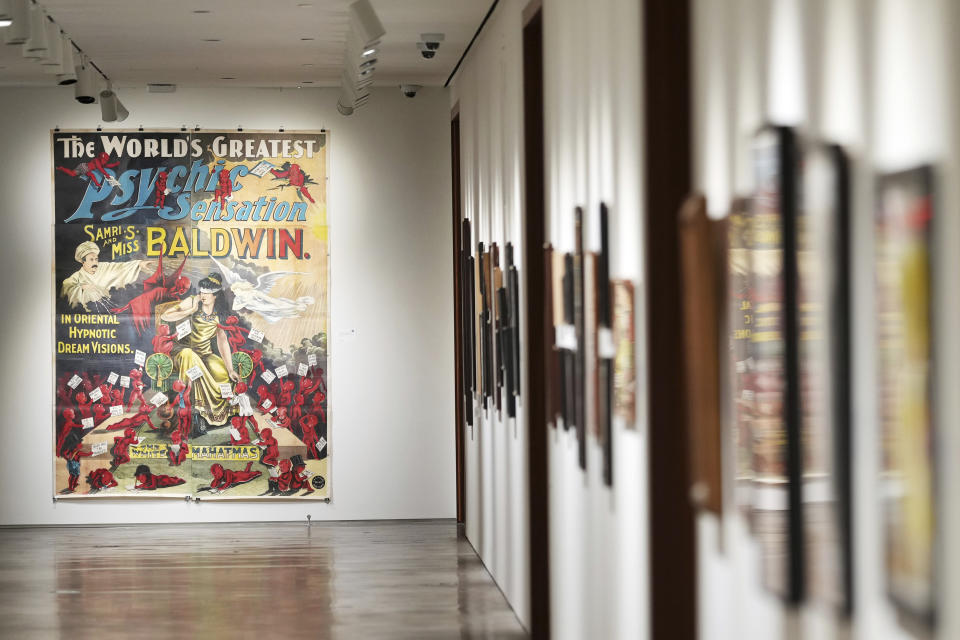 A woodblock poster featuring mentalists Samuel and Kitty Baldwin, from the Ricky Jay Collection, is displayed at Sotheby's on Friday, Oct. 22, 2021, in New York. The widow of the sleight-of-hand artist, card shark, author, actor and scholar turned over nearly 2,000 curiosities Jay collected to Sotheby's for an unusual auction. Divided into 634 lots, it's the focus of a live auction Wednesday and Thursday. (Photo by Charles Sykes/Invision/AP)