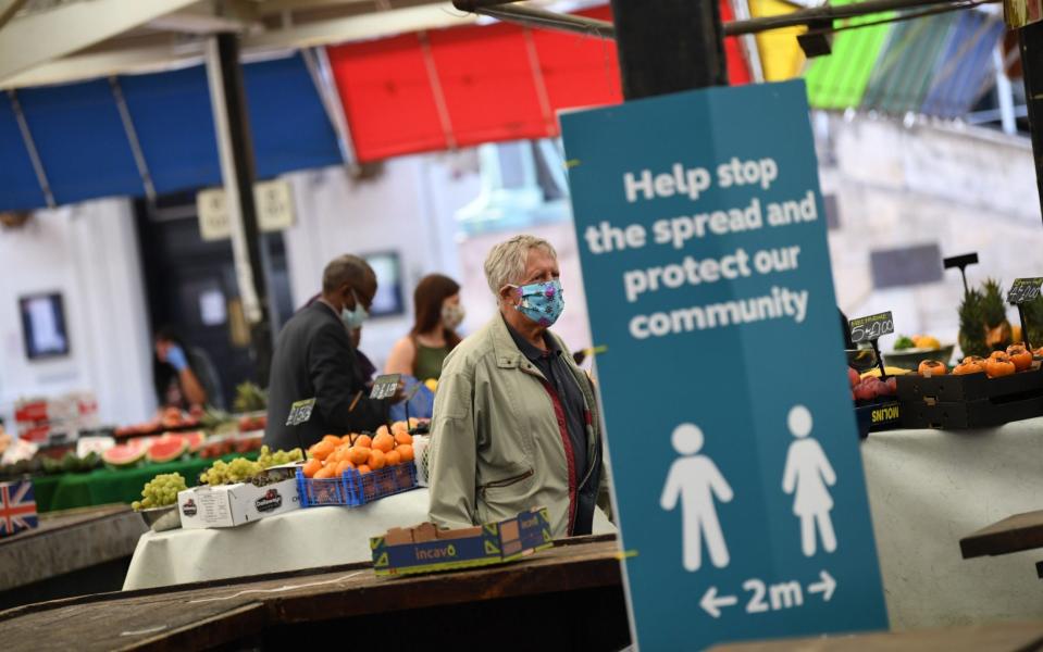 A poster in Leicester, where local lockdown restrictions have been imposed, urges people to keep their distance to stem the spread of the virus - Daniel Leal-Olivas/AFP