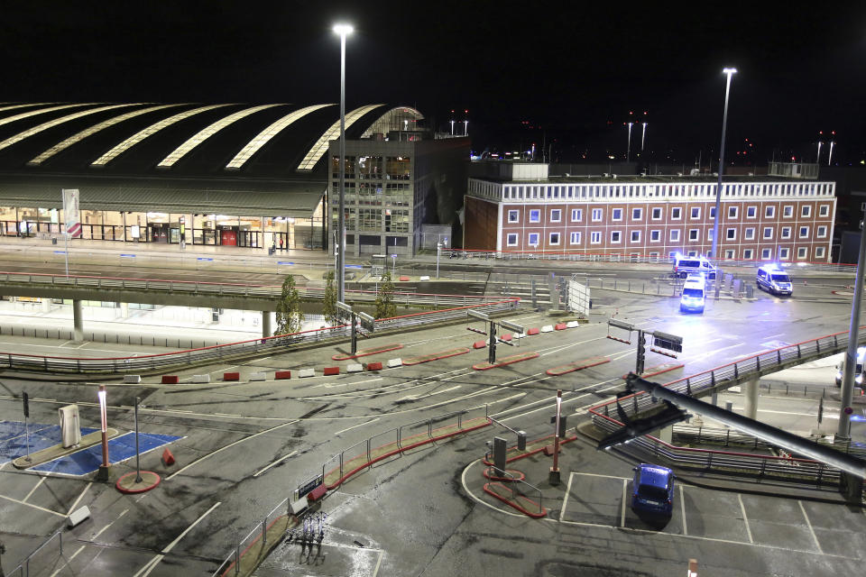 Police vehicles block access to Hamburg Airport during an operation, Saturday, Nov. 4, 2023, in Hamburg, Germany. The airport was closed to passengers and flights were canceled Saturday night after a vehicle broke through security and entered the premises, the German news agency dpa reported. (Bodo Marks/dpa via AP)