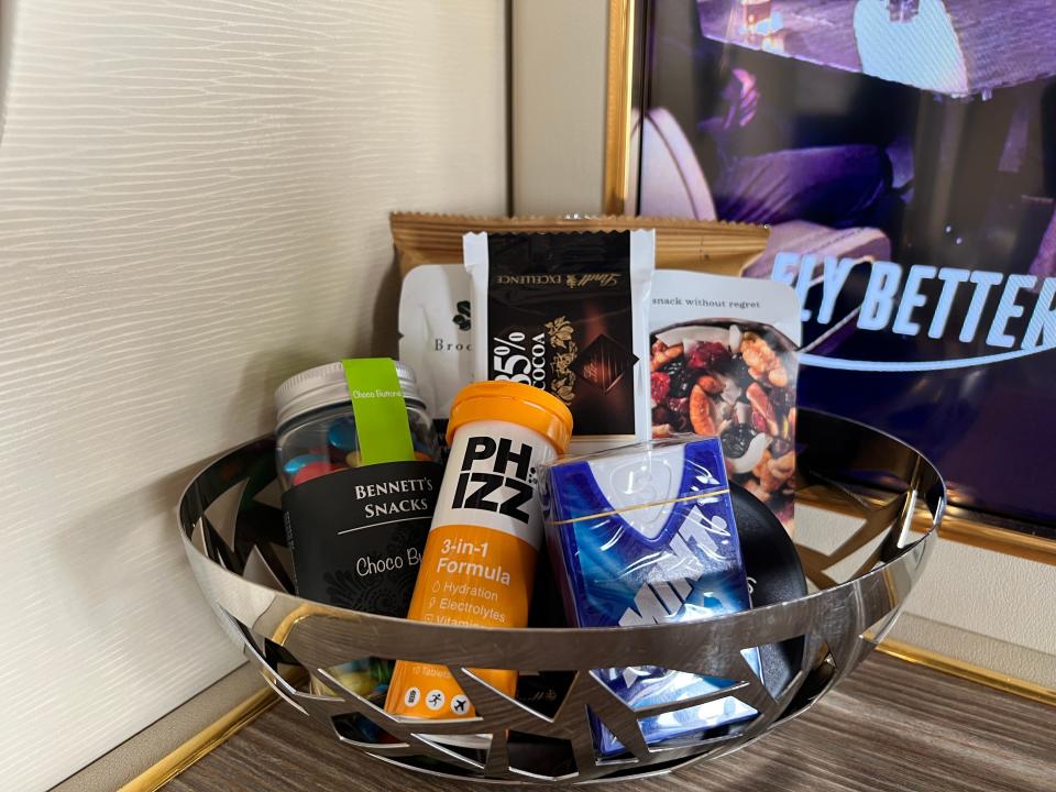 A close-up of the snack basket in an Emirates first class suite include Smint, chocolate buttons, nuts, and hydration tablets