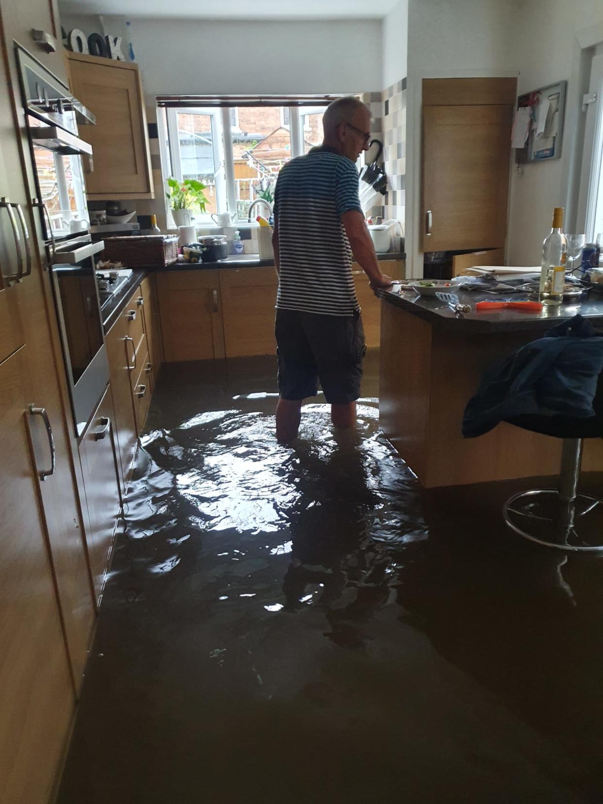 Nicola Thorogood's father in his flooded kitchen