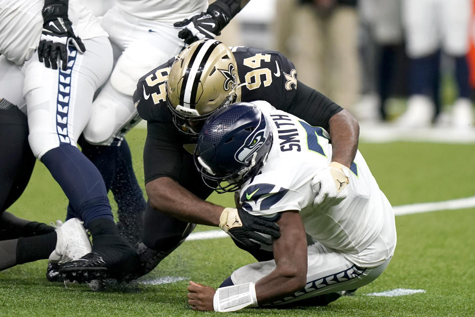 New Orleans Saints defensive end Cameron Jordan sacks Seattle Seahawks quarterback Geno Smith during an NFL football game in New Orleans, Sunday, Oct. 9, 2022. (AP Photo/Gerald Herbert)