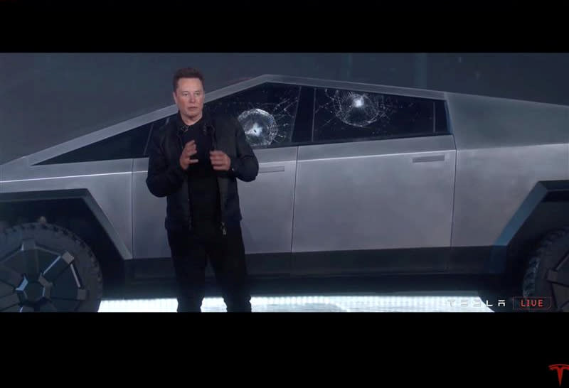 Tesla Chief Executive Elon Musk stands in front of the cracked windows of company's first electric pickup truck, the Cybertruck, after it was unveiled and a metal ball was thrown at the windows, in Los Angeles