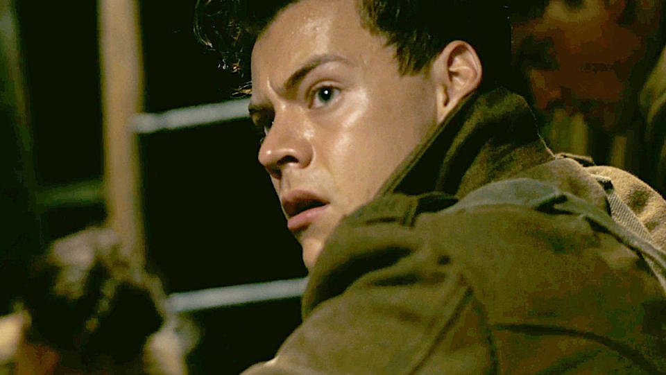 Harry Styles looks nervously over his shoulder in a scene from Dunkirk.