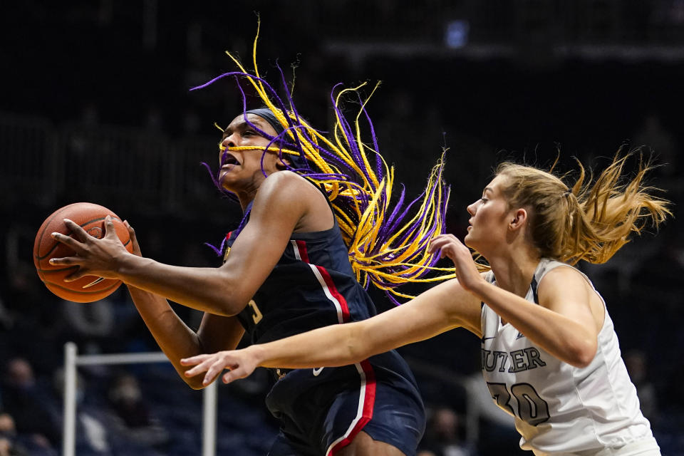 Connecticut forward Aaliyah Edwards (3) grabs a rebound in front of Butler guard Jaia Alexander (20) during the fourth quarter of an NCAA college basketball game in Indianapolis, Saturday, Feb. 27, 2021. (AP Photo/Michael Conroy)