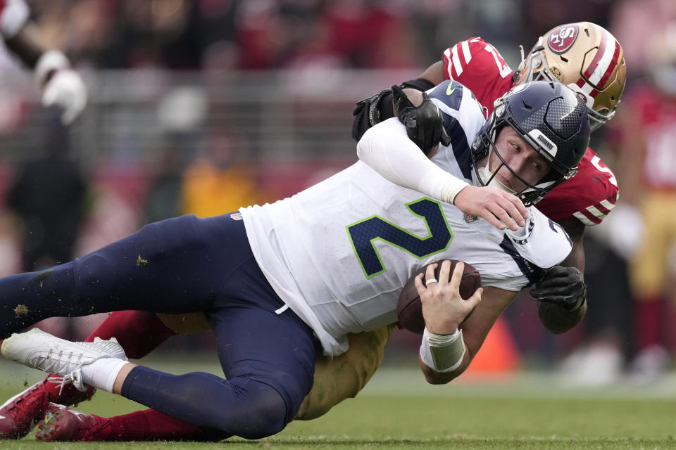 Seattle Seahawks quarterback Drew Lock (2) is tackled by San Francisco 49ers linebacker Dre Greenlaw during the second half of an NFL football game in Santa Clara, Calif., Sunday, Dec. 10, 2023. (AP Photo/Godofredo A. Vásquez)