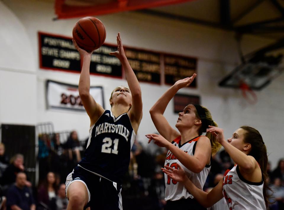 Marysville's Avery Wolters jumps for a layup as Marine City's Janie Ferrone attempts to block her during Marysville 47-42 road win at Marine City High School on Thursday, Jan. 13, 2022.