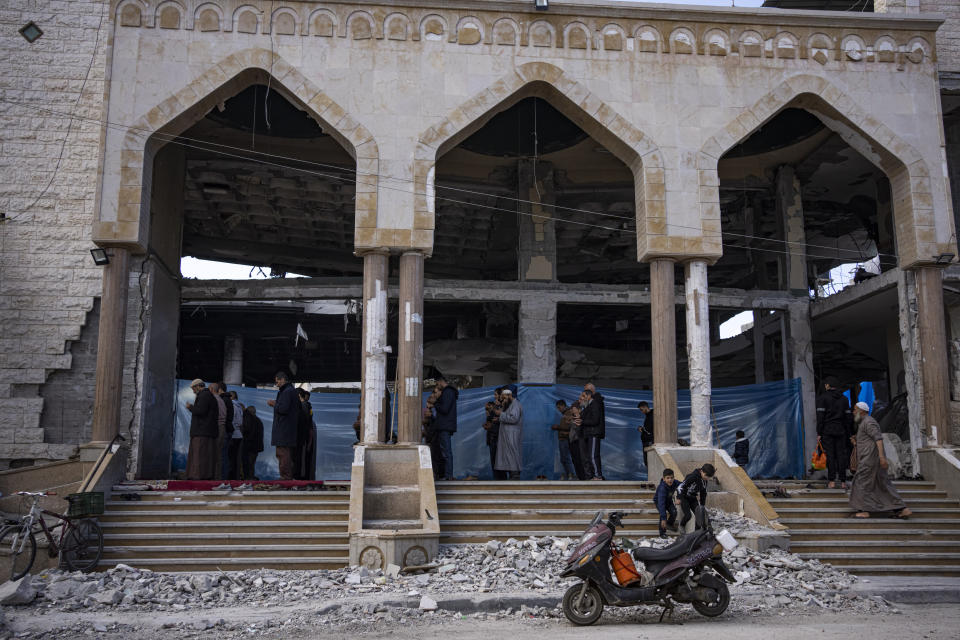 Palestinians pray in a damaged mosque following an Israeli strike in Rafah, southern Gaza Strip, Thursday, Feb. 15, 2024. (AP Photo/Fatima Shbair)