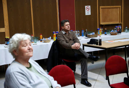 FILE PHOTO - Voters listen to a speech by Fidesz candidate, Denes Galambos at a campaign forum of the right-wing party in Ercsi, Hungary, March 9, 2018. REUTERS/Bernadett Szabo