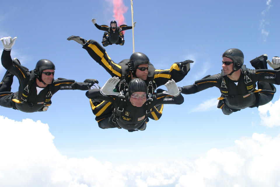 <em>George HW Bush carried out parachute jumps to mark his 75th, 80th, 85th and 90th birthdays. Here he jumped with the United States Army Golden Knights Parachute Team at the Bush Presidential Library near Houston, Texas on June 13, 2004 to celebrate his 80th birthday (Picture: PA)</em>