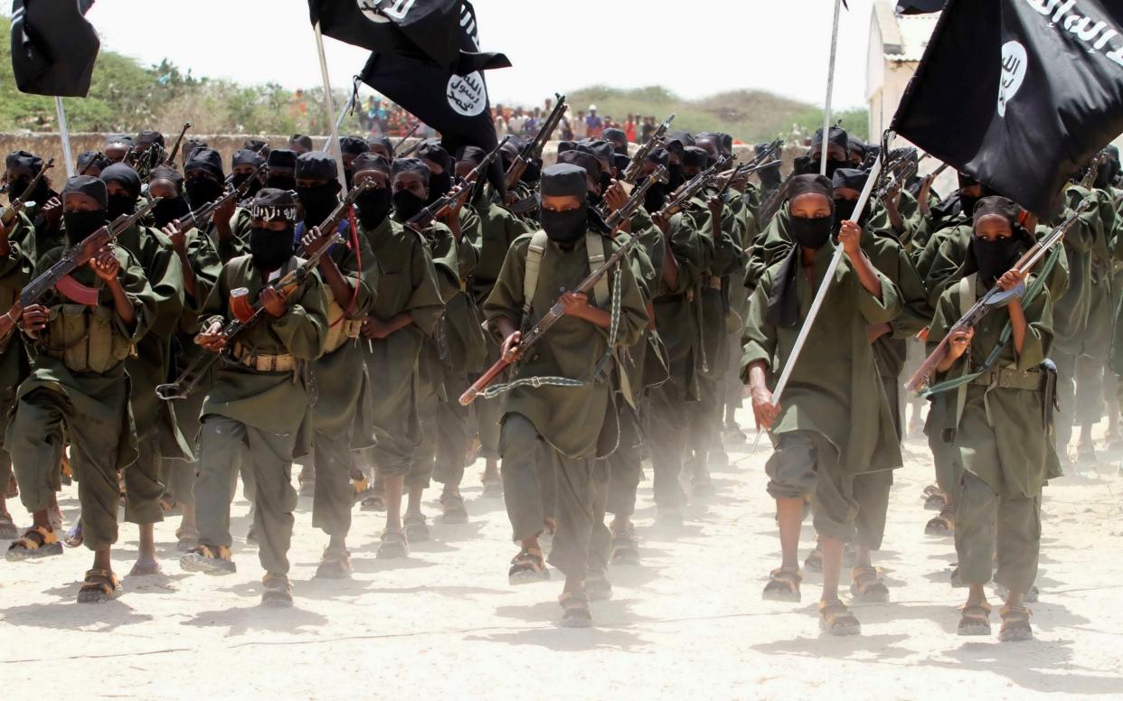 New recruits of Somalia's al-Qaeda linked al Shabaab militia march during a passing out parade at a military training base - FEISAL OMAR/Reuters