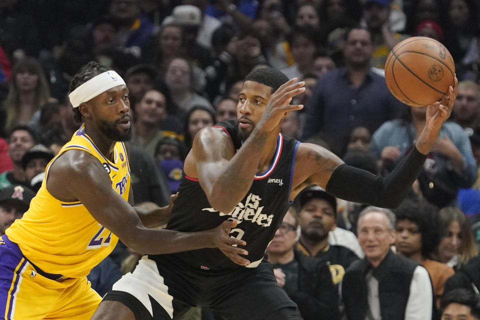 Los Angeles Clippers guard Paul George, right, tries to get pas Los Angeles Lakers guard Patrick Beverley during the first half of an NBA basketball game Wednesday, Nov. 9, 2022, in Los Angeles. (AP Photo/Mark J. Terrill)