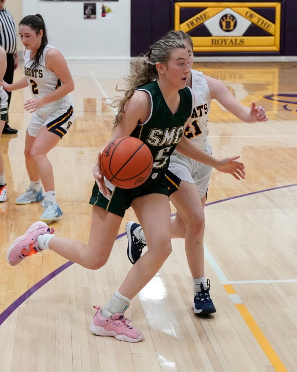 Brooke Mossburg of St. Mary Catholic Central drives the baseline against Whiteford’s Alyssa Ulery during a 40-20 SMCC win in the semifinals of the Division 3 District at Blissfield Wednesday.