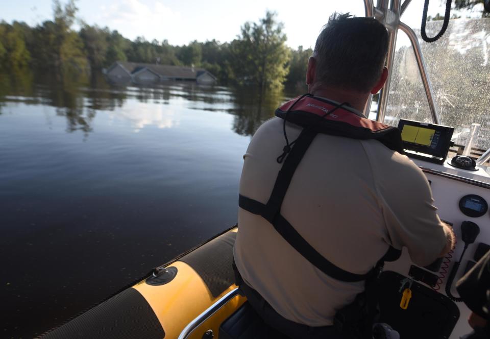 Pender County Sheriff's Office Lt. Keith Ramseylooks around during rescue operations on areas flooded from the Northeast Cape Fear River in Burgaw, N.C., Wednesday, September 19, 2018. The river had severe flooding due to the rains from Hurricane Florence.