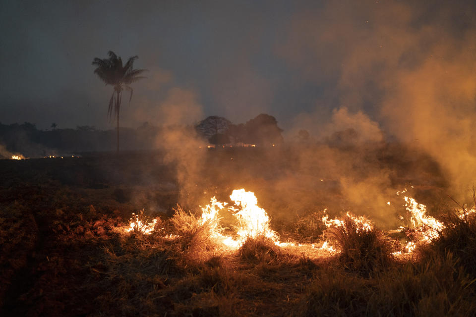 A fire burns a field on a farm in the Nova Santa Helena municipality, in the state of Mato Grosso, Brazil, Friday, Aug. 23, 2019. Under increasing international pressure to contain fires sweeping parts of the Amazon, Brazilian President Jair Bolsonaro on Friday authorized use of the military to battle the massive blazes. (AP Photo/Leo Correa)