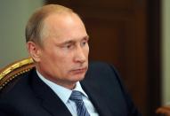 Russia's President Vladimir Putin attends a meeting in his Novo-Ogaryovo residence outside Moscow, on July 29, 2014