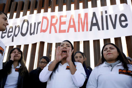 FILE PHOTO: 'Dreamers' react as they meet with relatives during the 'Keep Our Dream Alive' binational meeting at a new section of the border wall on the U.S.-Mexico border in Sunland Park, U.S., December 10, 2017. REUTERS/Jose Luis Gonzalez/File Photo