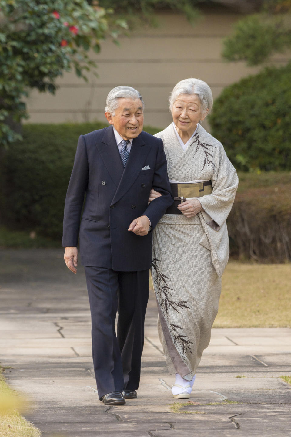 In this Monday, Dec. 10, 2018, photo released on Friday, Dec. 21, 2018, by the Imperial Household Agency of Japan, Japan's Emperor Akihito, left, and Empress Michiko, right, take a stroll at the garden of the Imperial Palace in Tokyo. Emperor Akihito, who turns 85 on Sunday, Dec. 23, and will abdicate this spring, says he feels relieved to see the era of his reign coming to an end without having seen his country at war. (The Imperial Household Agency of Japan via AP)